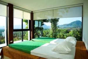 a bedroom with two beds and a large window at Andakiri Pool Villa Panoramic Sea View - SHA Certified in Ao Nang Beach