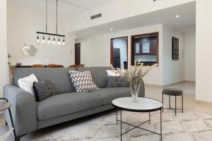 a living room with a gray couch and a table at GuestReady - Infinite Dreams in Dubai