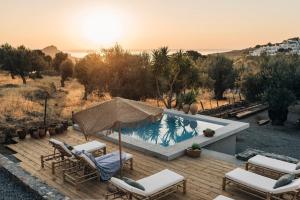 a deck with chairs and a swimming pool at Casita Casita Lindos - Adults Only in Líndos