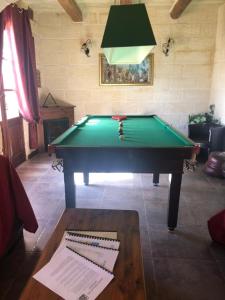 a room with a pool table in a room with a lamp at Blueberry Hills in Żejtun