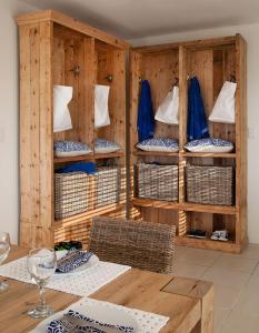 a room with wooden shelves with baskets and a table at Rockshandy Beachhouse in Southbroom