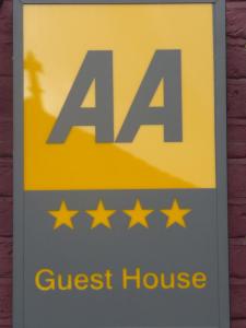 a sign for a guest house with four stars at Crompton Guest House in Hounslow
