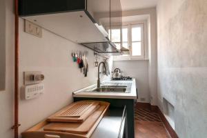 a small kitchen with a sink and a stove at Appartamento nel Parco di Villa Erba in Cernobbio