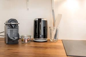 a kitchen counter with a coffee maker on a table at DIFY Jaboulay - Jean Macé in Lyon