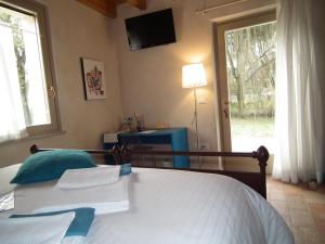 Postel nebo postele na pokoji v ubytování L'Isolo b&b e case vacanza
