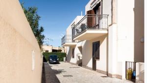 a car parked on a street between two buildings at Hibiscus in San Vito lo Capo