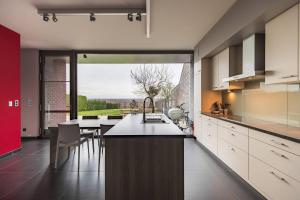 a kitchen with a counter and a large window at La Maison de Marie in Borgloon