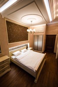 a bedroom with a bed and a chandelier at Kyiv 2Rooms Classic Apartment in Kyiv
