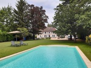 a swimming pool in the yard of a house at le domaine du chaffard in Les Avenières