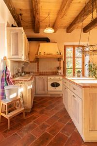 a kitchen with white cabinets and a tile floor at Castellino Bella Vista in Ponte Tresa