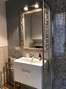 a bathroom with a sink and a mirror at Casa Bacìomari in Bologna +11 photos