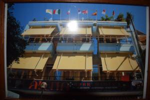 a building with flags on top of it at Alena Apartments in Chania