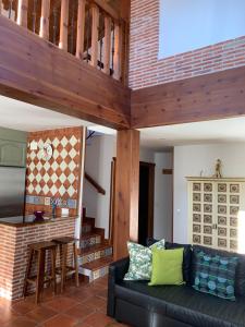 a living room with a couch and a table at La Casa De La Abuela in Ortigosa del Monte