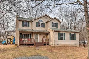a large house with a porch and aintendent at Walk to Pool and Lake Albrightsville Vacation Home! in Albrightsville