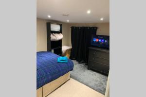 a bedroom with a bed and a flat screen tv at a COSY CLEAN GROUND FLOOR FLAT CLOSE TO TOWN CENTRE in Boston