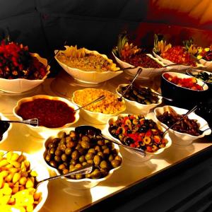 a table filled with lots of different types of food at Wadi Rum UFO Luxotel in Wadi Rum