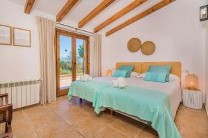 a bedroom with two beds and a large window at Villa Font Xica Petit by Sealand Villas in El Port +18 photos