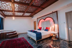 a bedroom with a bed with a large headboard at TS Gold Otel in Trabzon