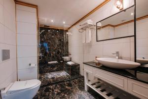 a bathroom with a sink and a toilet and a shower at TS Gold Otel in Trabzon