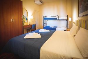 a hotel room with a bed with towels on it at Hotel Posta in Cecina