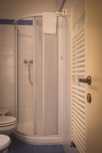 a bathroom with a shower and a toilet at Hotel Posta in Cecina