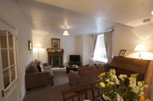 a living room with a couch and a fireplace at Allan Stream Apartment in Bridge of Allan