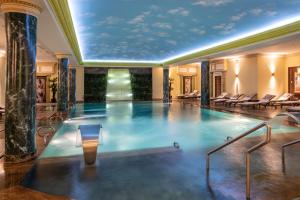 a large swimming pool in a large room at Swiss Diamond Hotel Prishtina in Prishtinë