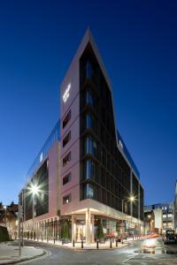 a building on a street at night at Marlin Hotel Stephens Green in Dublin