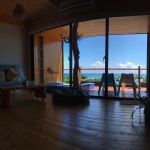 a living room with a view of a balcony at Kenting Nanwan AlohaInn in Nanwan