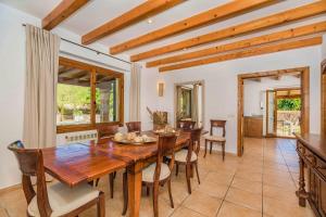 a dining room with a wooden table and chairs at Villa Font Xica Petit by Sealand Villas in El Port