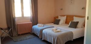 Postel nebo postele na pokoji v ubytování Hôtel Terminus