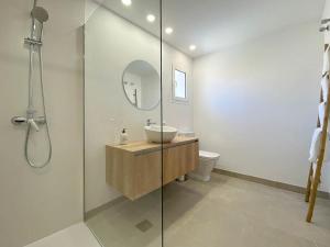 a bathroom with a sink and a glass shower at Record Maritim II in Port d'Alcudia