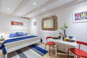 a bedroom with a bed and a table and chairs at Apartment Neva in Dubrovnik