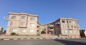 an apartment building on the corner of a street at Beachfront Apartment @ Morleenpark unit 11 in Swakopmund
