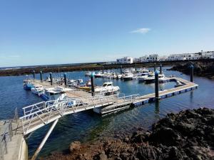 a group of boats docked at a marina at Rincón del descanso in Órzola