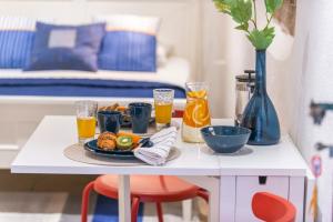 a table with a tray of food and orange juice at Apartment Neva in Dubrovnik