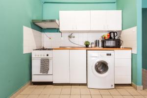 a white kitchen with a washing machine in it at Apartment Jeseniova in Prague