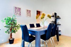 a dining room with a blue table and chairs at Valletta 2 bedroom sleeps 6 apartment walking distance to centre and the sea in Valletta