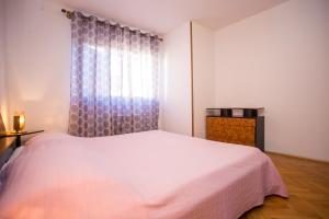 Postel nebo postele na pokoji v ubytování Apartman M&M Žminj