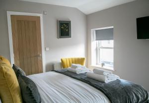 a bedroom with a bed with towels on it at Alpha Spa classic 1 bedroom apartment in Harrogate