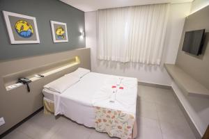 Cama ou camas em um quarto em Hotel Morada do Sol