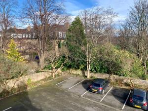 two cars parked in a parking lot under a bridge at Northumberland Hotel in Edinburgh