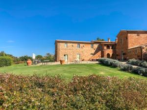 una gran casa de ladrillo con un patio delante en Casale Cardini, en Foiano della Chiana