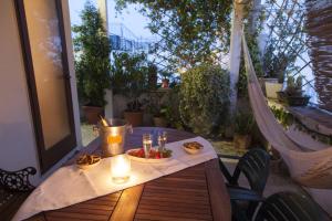 a table with a plate of food and candles on a patio at Dimora Antica Perla in Fasano