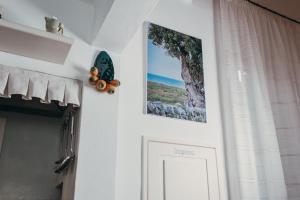 a white door with a picture and a butterfly on it at Dimora Antica Perla in Fasano