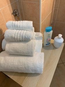a stack of towels on a counter in a bathroom at Poggio del Sole Guest House in Arezzo