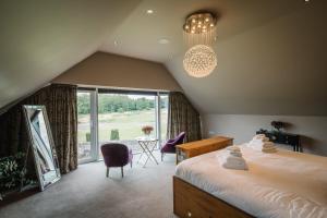 a bedroom with a large bed and a large window at Carus House @ Carus Green in Kendal