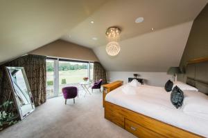 a bedroom with a bed and a large window at Carus House @ Carus Green in Kendal