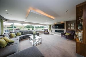 a living room with a couch and a table at Carus House @ Carus Green in Kendal