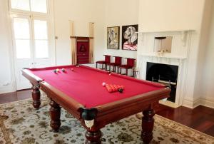 a red pool table in a room with a fireplace at Laurelville in York